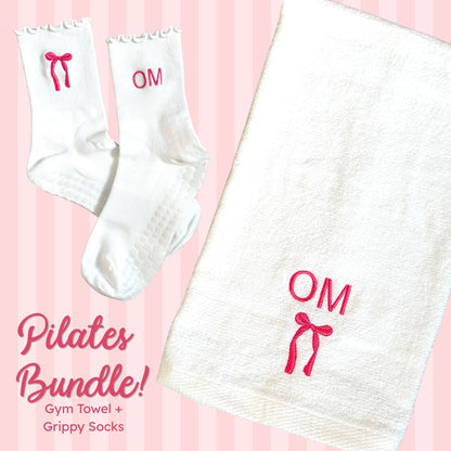 white ruffle grip socks with custom bow and initial embroidery and a white gym towel with initial and bow embroidery in pink thread