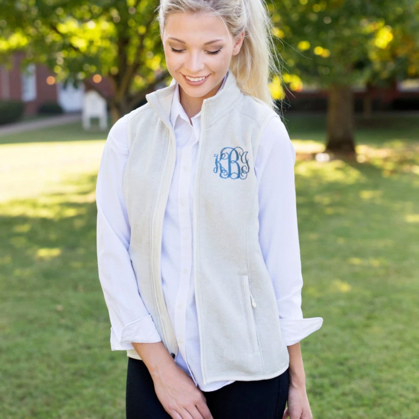 woman wearing a knit fleece vest with monogram on the left chest