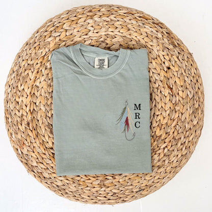 Bay Comfort Colors tshirt with custom fly fishing hook embroidered design featuring a mini initial monogram vertically next to it on the left chest 