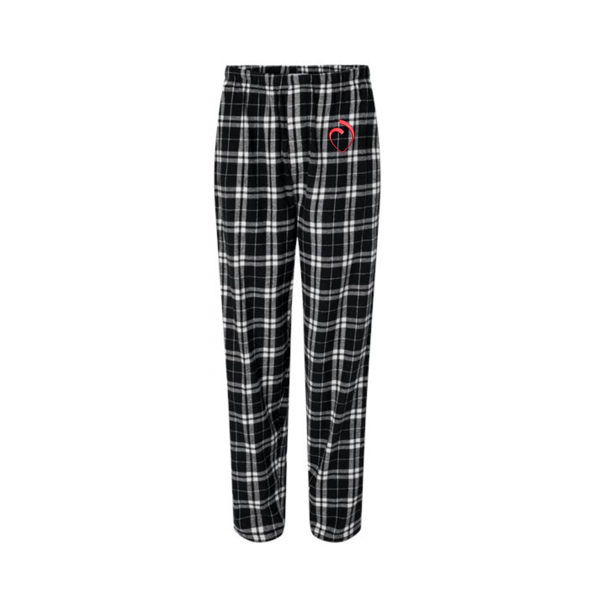 black and white plaid pajama pants with the sacred heart schools logo embroidered in red on the left leg pant pocket area