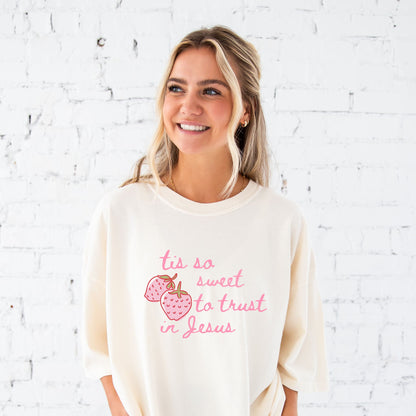 girl wearing an ivory comfort colors t-shirt with custom tis so sweet to trust in jesus strawberry print design