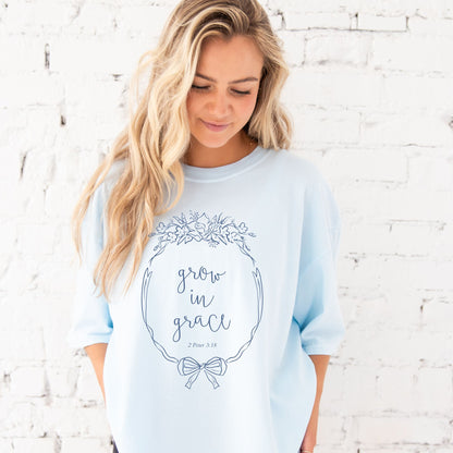 girl wearing a chambray comfort colors t-shirt with custom grow in grace floral frame printed designv