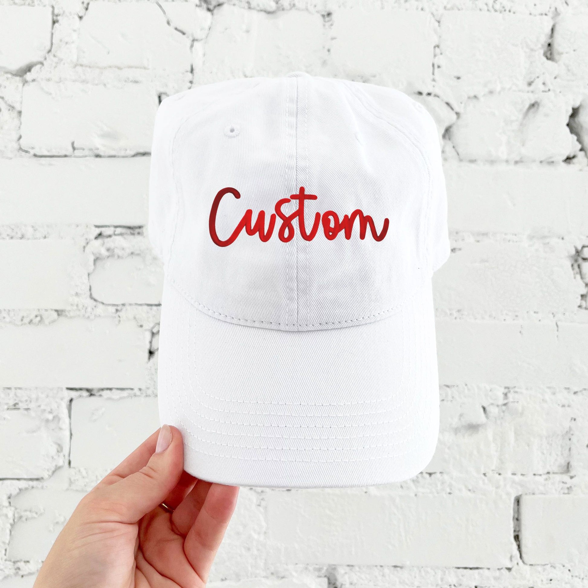 white baseball hat with custom puff print red embroidered design