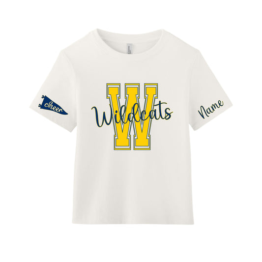 An off-white short-sleeve t-shirt with a yellow and navy blue 'W Wildcats' graphic on the front, featuring a navy blue 'Cheer' banner on the right sleeve and 'Name' text on the left sleeve.