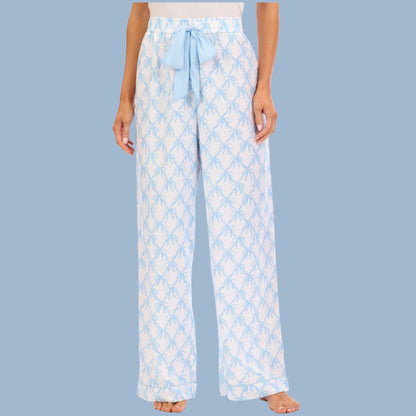 Light blue patterned pajama pants worn by a person on a light blue background