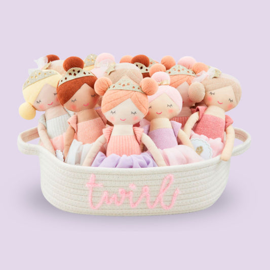 Set of small dolls in a basket with 'twirl' text on a light purple background