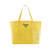 A bright yellow canvas tote bag with two shoulder straps, featuring a front pocket with the word 'Name' and a small bow design in navy, and a translucent side panel with partial lettering.