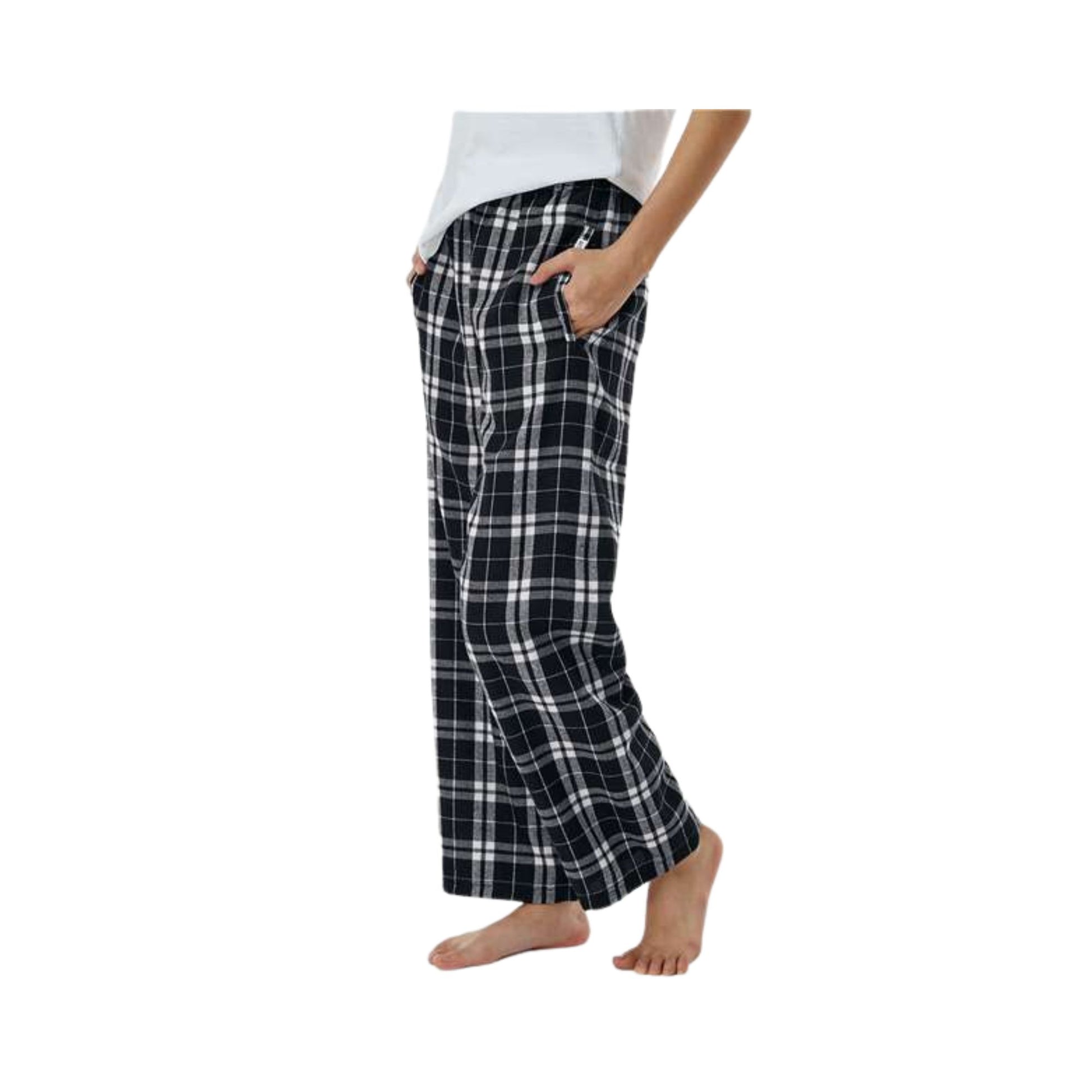side view of boy wearing black and white plaid pajama pants with his hand in a pocket