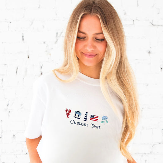 Woman wearing a white t-shirt with customizable text and icons on a light brick wall background