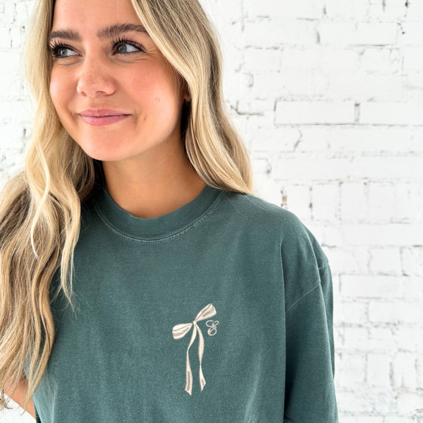 blue spruce comfort colors t-shirt with embroidered ribbon bow and cursive initial embroidered on the left chest in natural thread