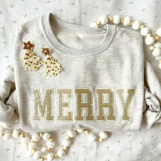 heather oatmeal crewneck with a sparkly gold merry design embroidered design across the chest