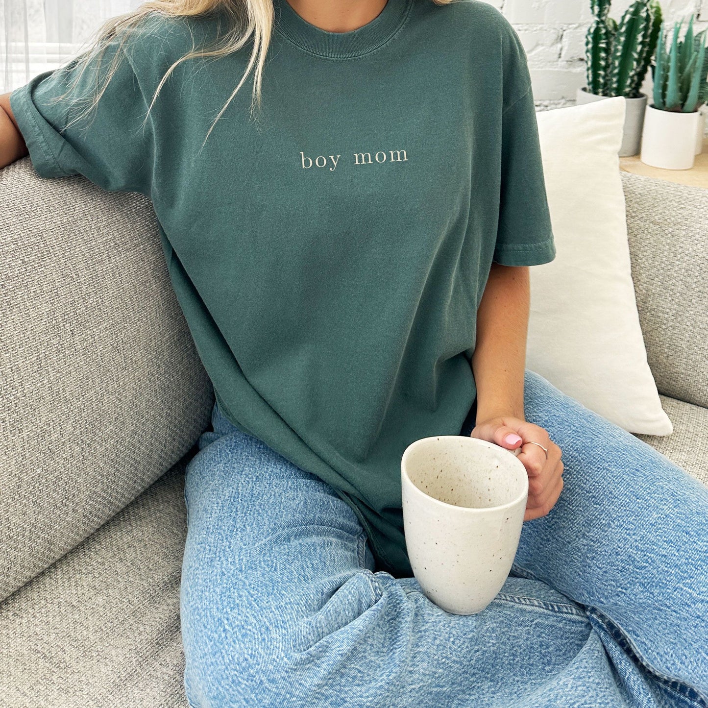 woman wearing a blue spruce comfort colors tee with custom mama embroidered design in a natural thread