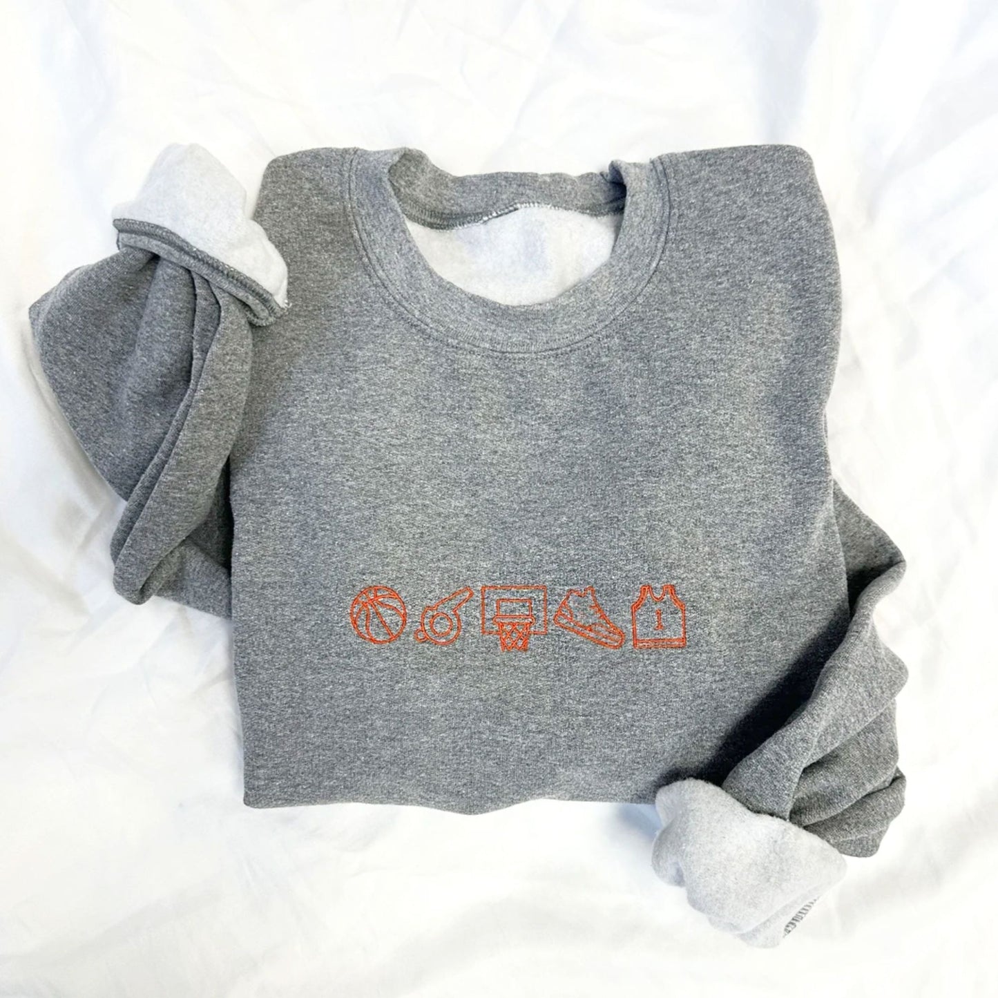 Gray sweatshirt with orange graphics on a white background