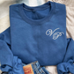 indigo blue crewneck sweatshirt with an edwardian script initial monogram on the left chest in white thread