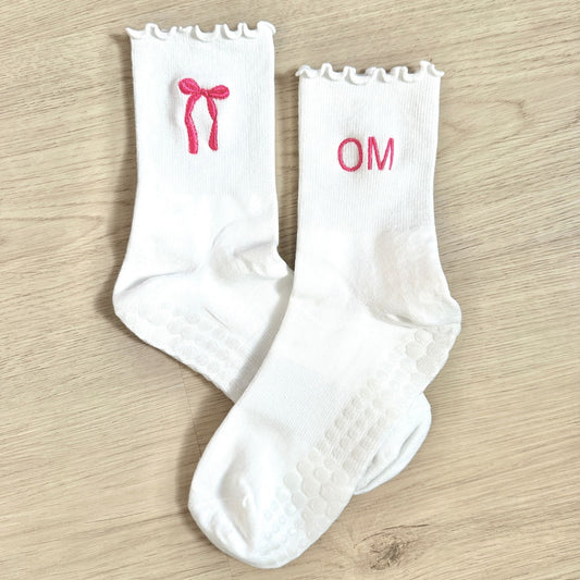 white ruffle grip socks with custom bow and initial embroidery in pink thread