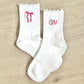 white ruffle grip socks with custom bow and initial embroidery in pink thread