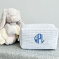 blue and white striped quilted pouch with custom monogram embroidered in font 10 and royal blue thread.
