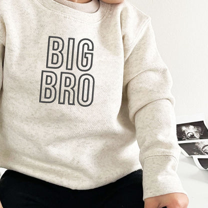 little boy wearing a natural heather crewneck with custom BIG BRO embroidery in outlined letters on the center chest in black thread