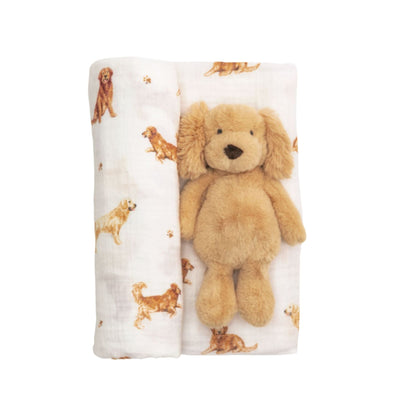 Plush golden retriever dog on a blanket with dog pattern on a white background