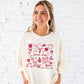 Woman wearing an ivory t-shirt with red football doodled icons and game day text 