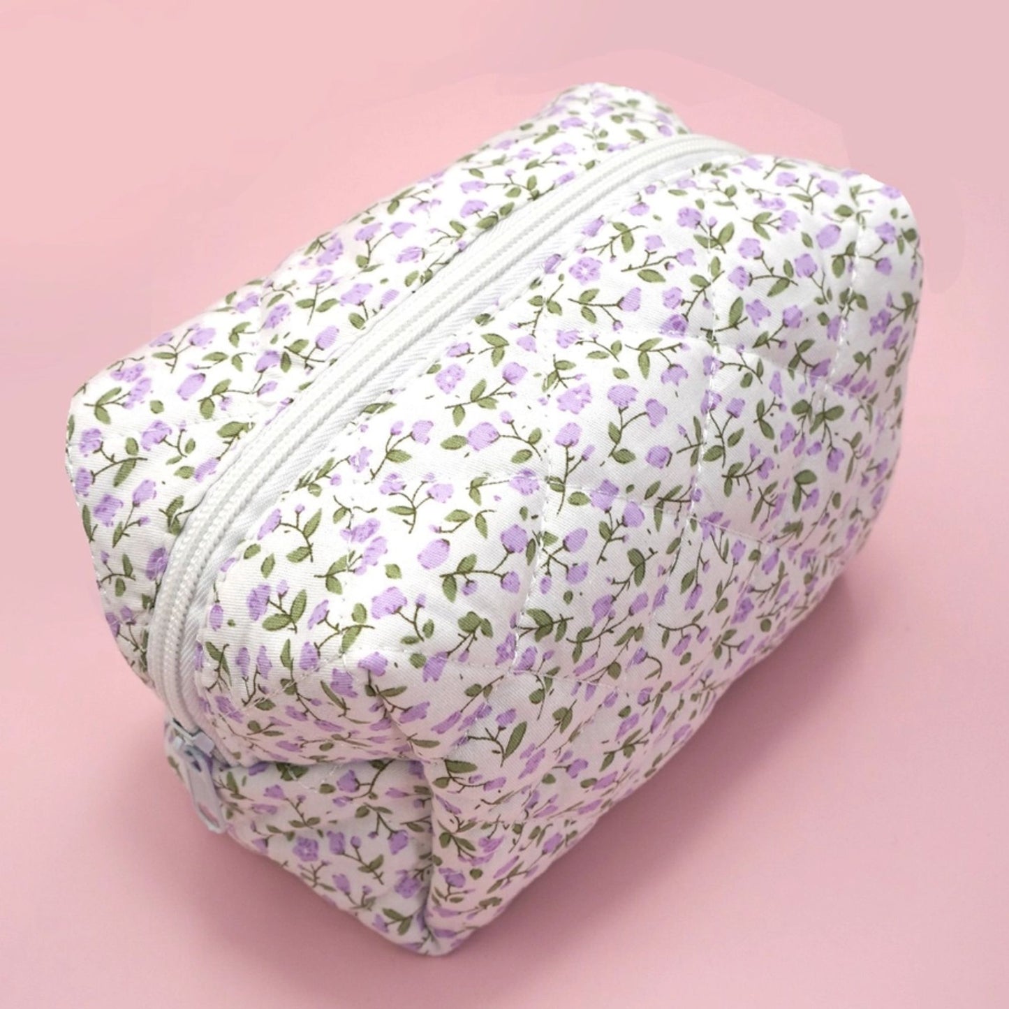 Floral-patterned pouch on a pink background