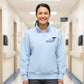 Person wearing a light blue quarter zip sweatshirt with a name and caduceus design on the left chest in a hospital hallway