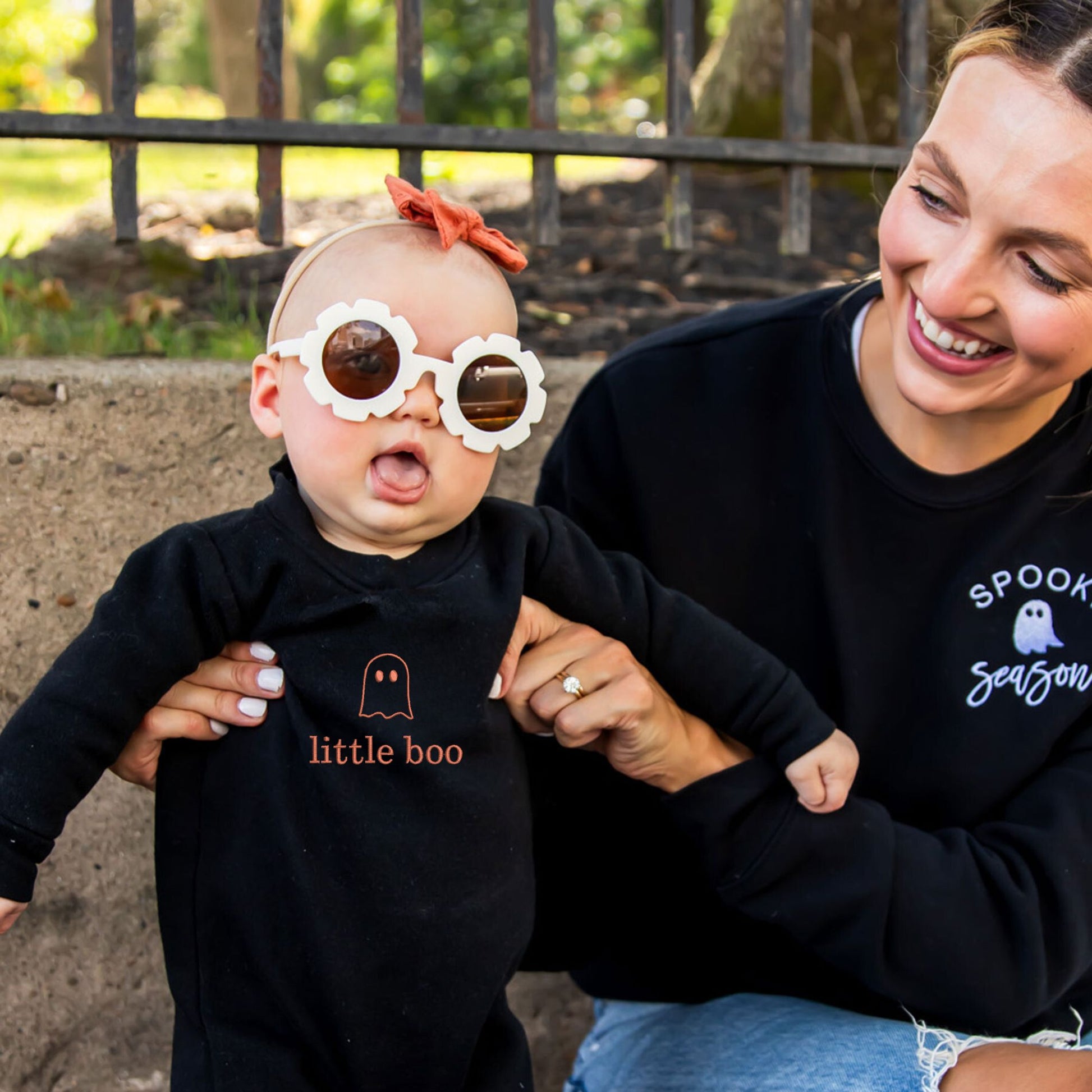 baby girl wearing a black long sleeve bodysuit with a cute ghost little boo embroidered design