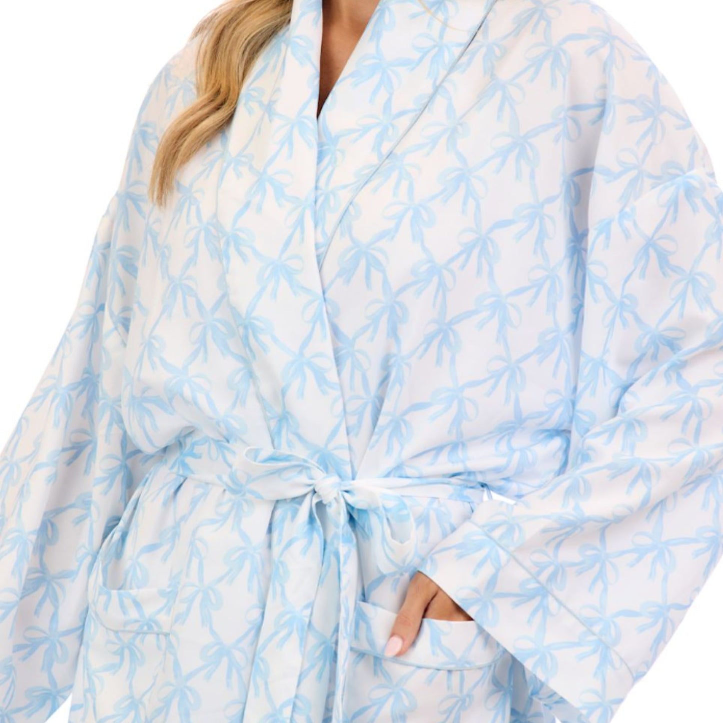 Woman wearing a light blue and white patterned robe on a white background
