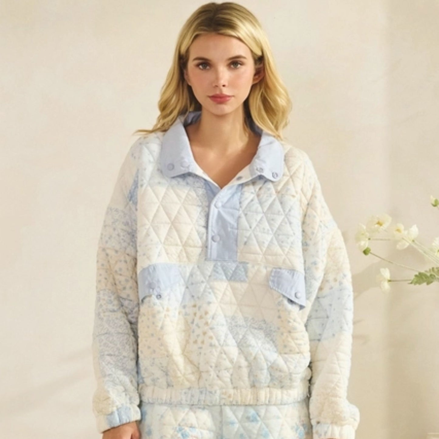 Woman wearing a quilted jacket with a neutral background