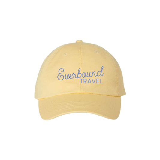 Yellow cap with 'Everbound Travel' text on a white background
