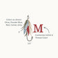 detailed image of an embroidered design of a fly fishing lure/hook with olive, blue, red, and camel feathers paired with a single mini intial monogram
