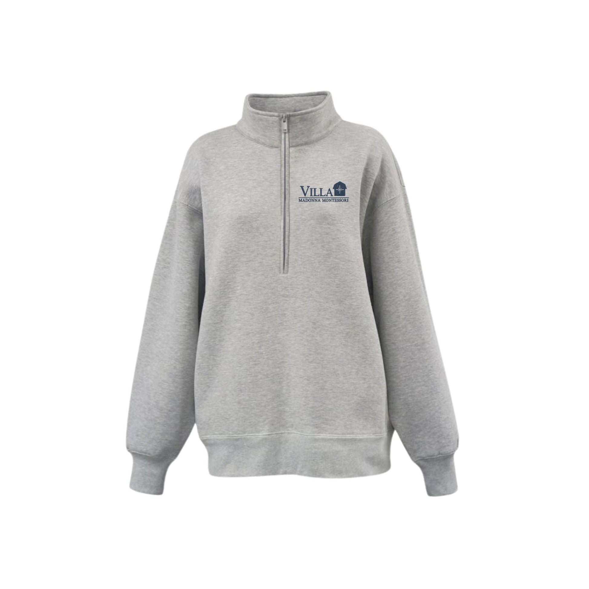 A light gray heather quarter-zip sweatshirt with a mock neck collar, featuring a navy blue embroidered logo on the left chest that reads 'Villa Madonna Montessori. The sweatshirt is displayed on a clean white background.