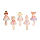 Five small dolls in colorful dresses on a white background