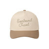 two tone beige trucker hat with custom everbound travel embroidered design 