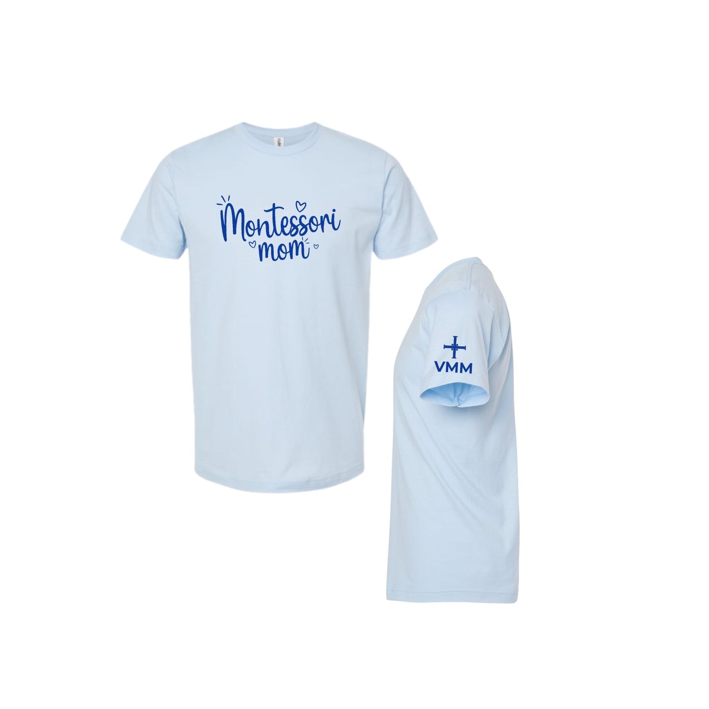 A light blue short-sleeve t-shirt shown from the front and side. The front features the text 'Montessori mom' in blue script, and the side view shows 'VMM' with a small cross printed on the sleeve.