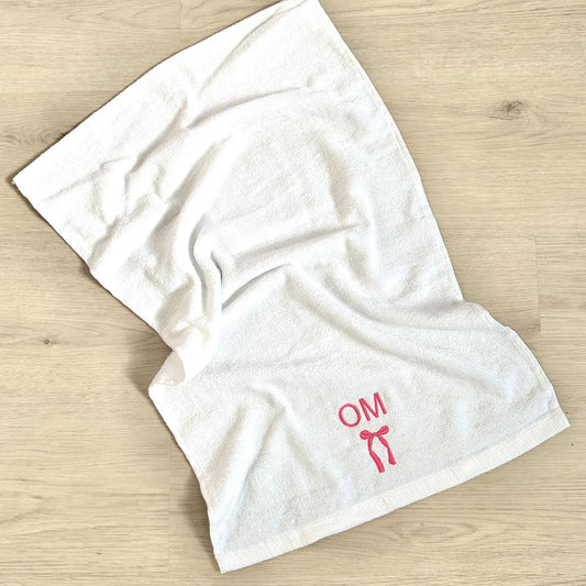 white gym hand towel with custom two letter and bow embroidered design in pink thread