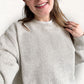 Person wearing the latte cozy knit fleece crew against a white background