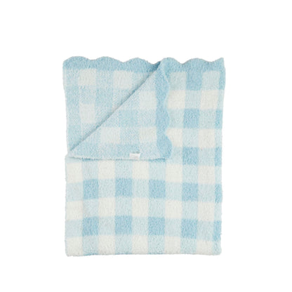 Folded blue and white checkered blanket on a white background