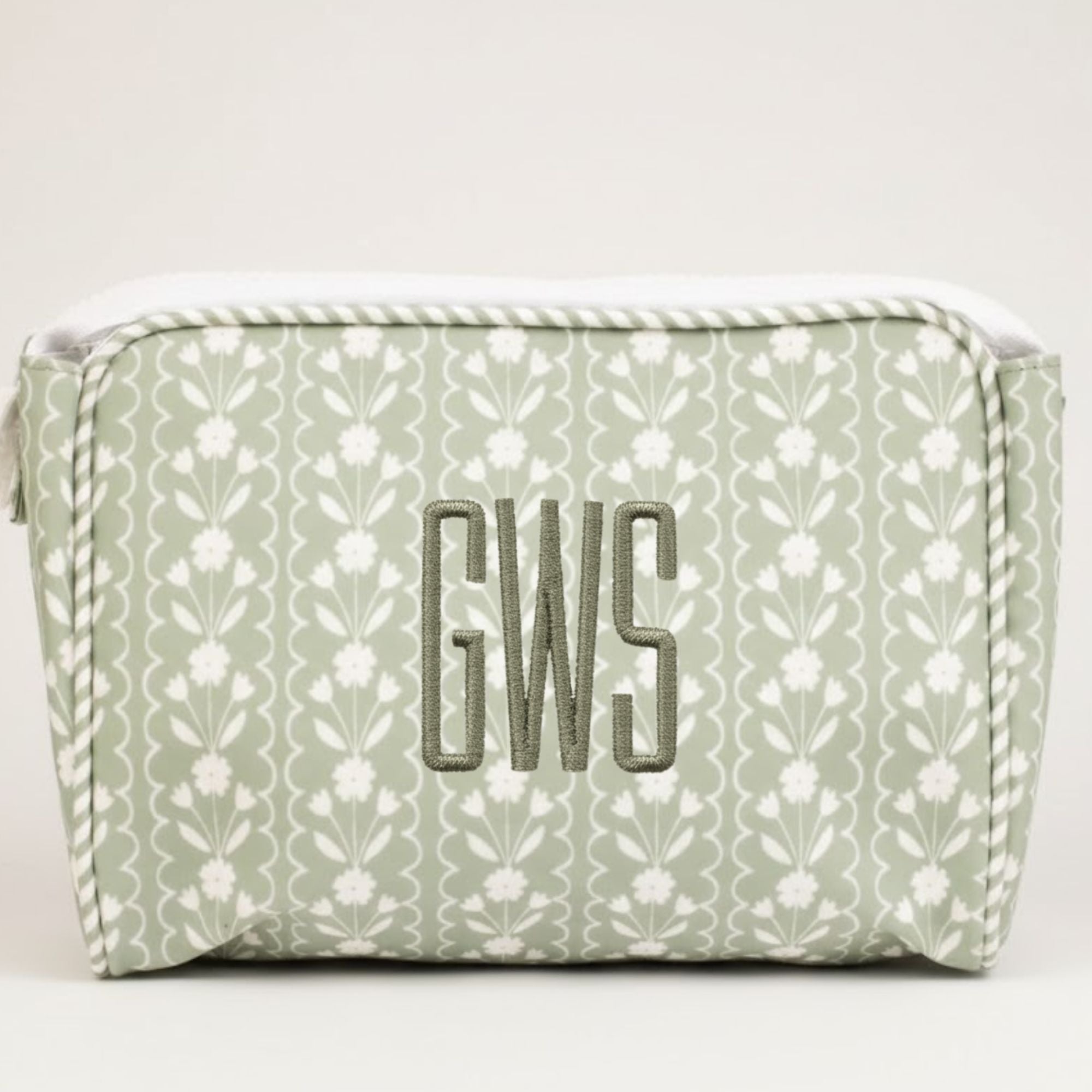 Green floral-patterned pouch with 'GWS' monogram on a white background