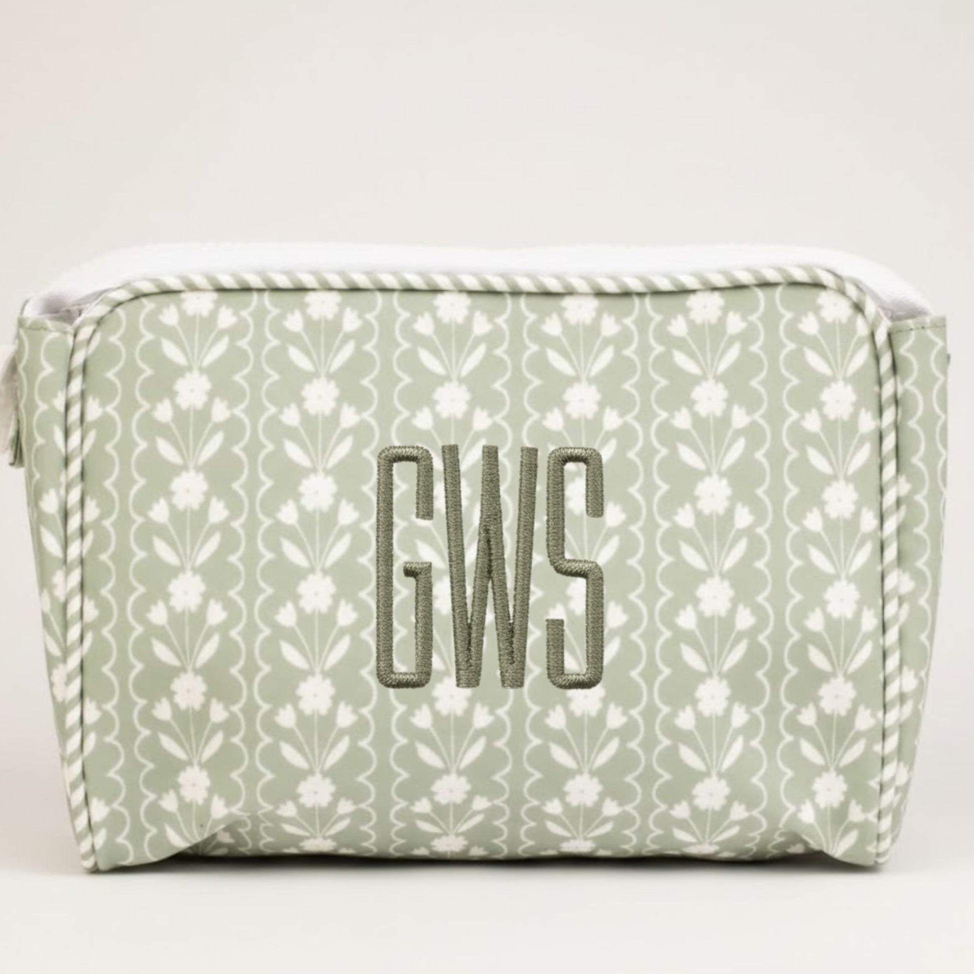 Green floral-patterned pouch with 'GWS' monogram on a white background