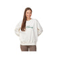 woman wearing a ladies boxy bleached linen crewneck with embroidered panthers design in script font on the front center chest with hunter green thread