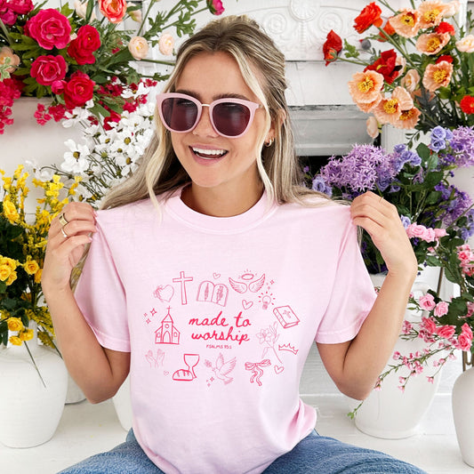 girl wearing a blossom comfort colors t-shirt with custom made to worship printed design featuring cute Christian themed drawn icons