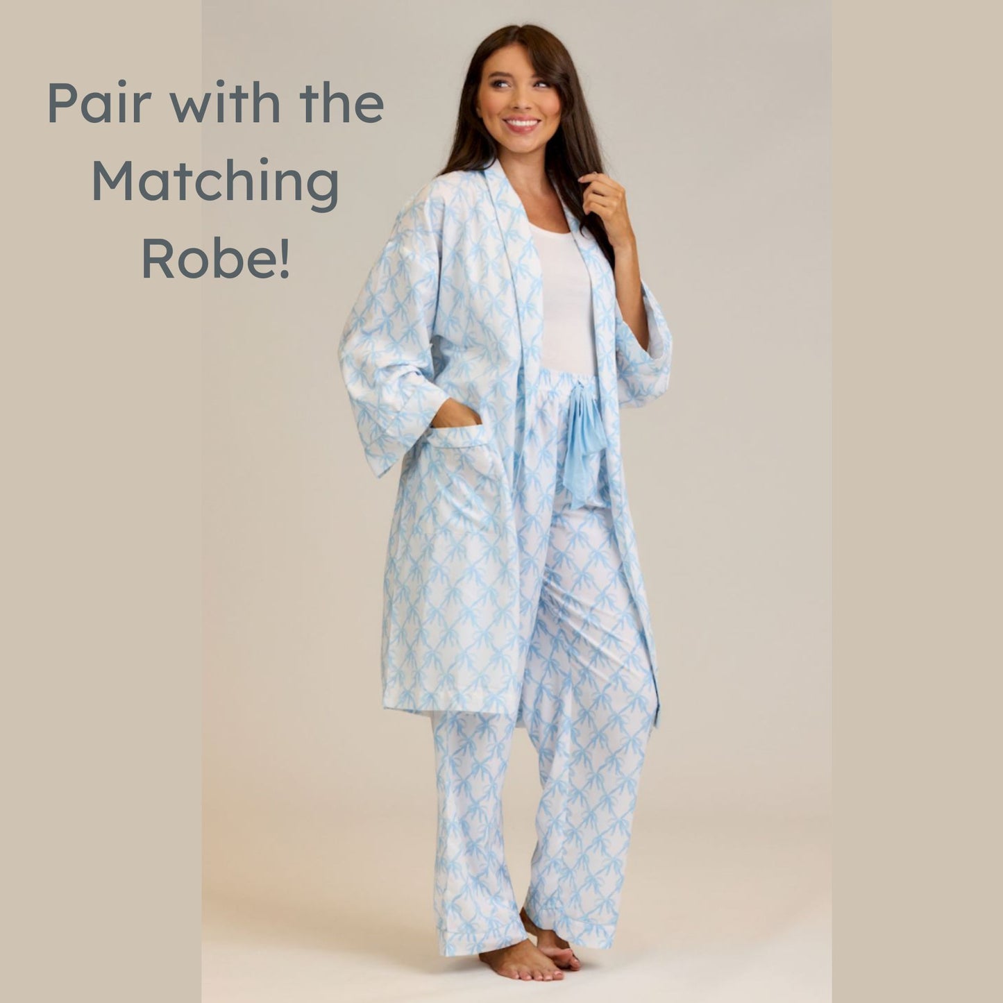 Woman wearing a light blue patterned robe and pajama set on a beige background