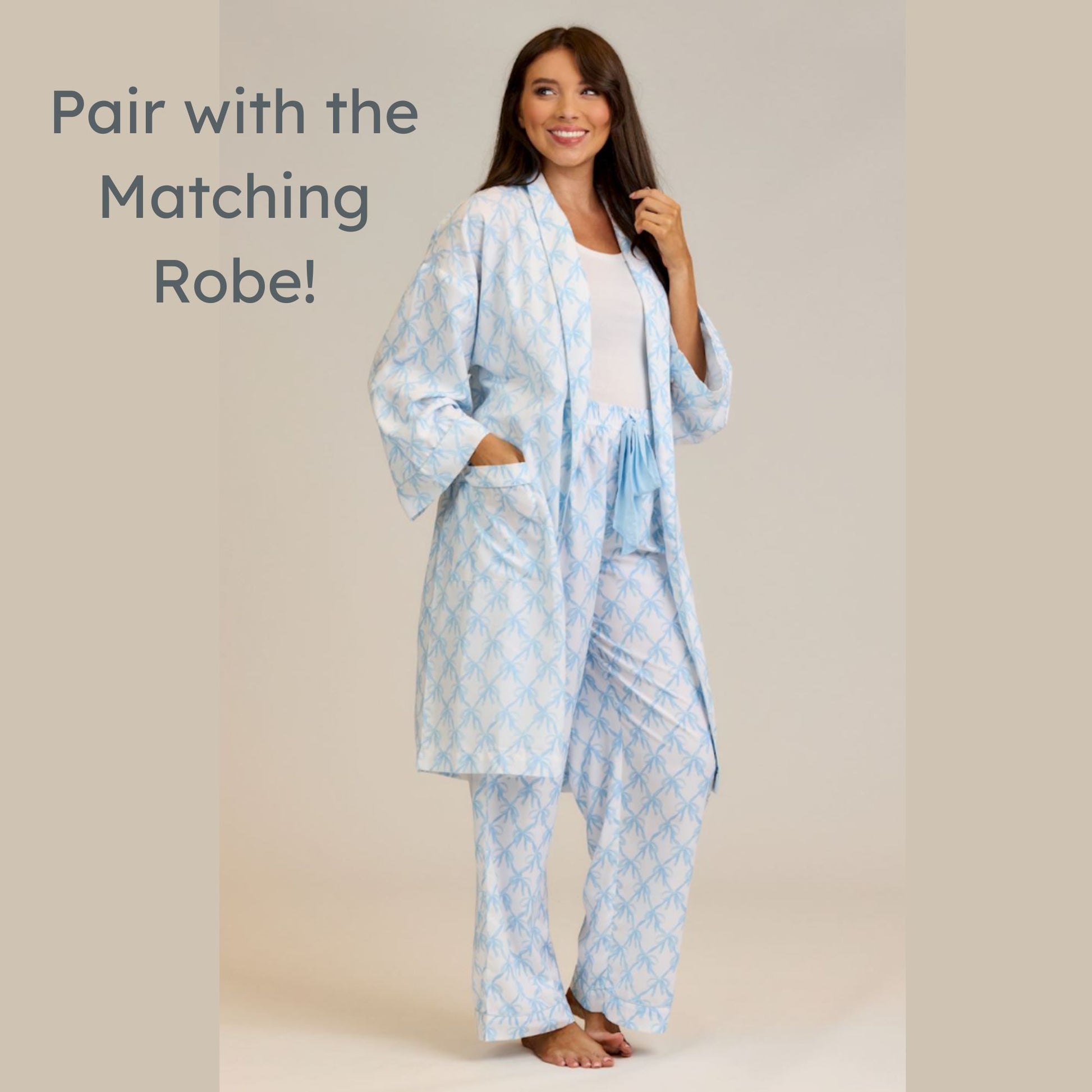 Woman wearing a light blue patterned robe and pajama set on a beige background