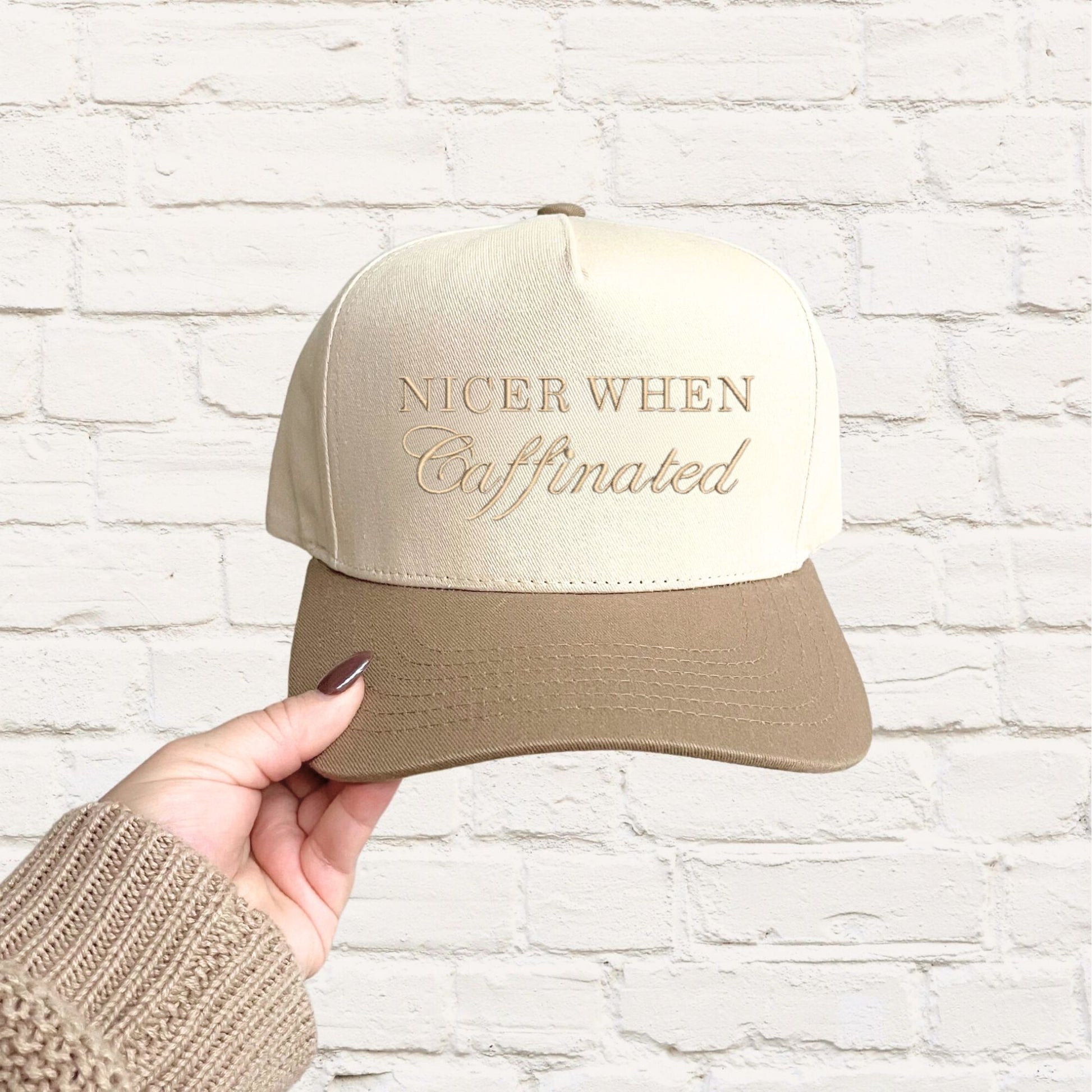 beige two-tone trucker hat with a custom nicer when caffeinated embroidered design in camel thread