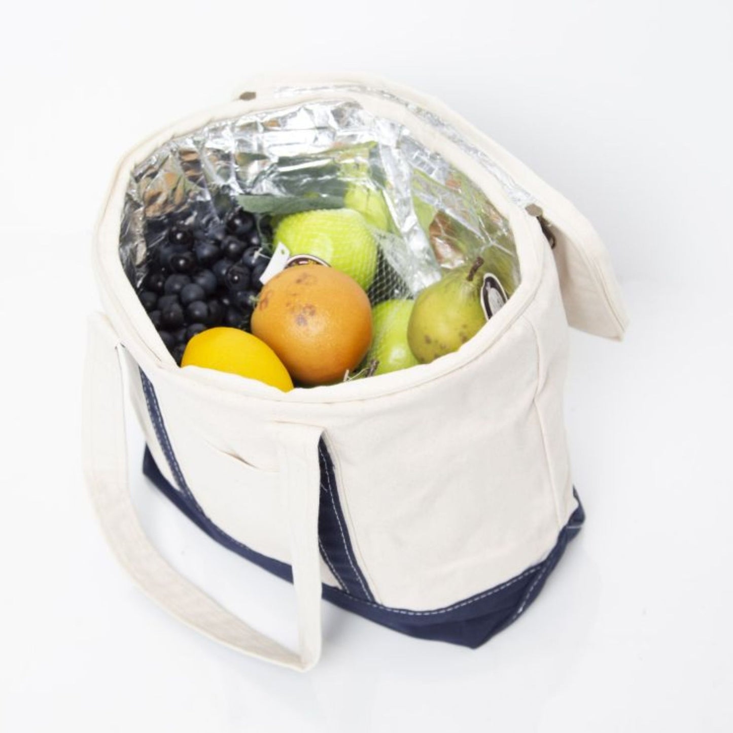 Fruit and vegetables in an insulated cooler bag on a white background