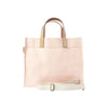 Pink tote bag with beige handles and strap on a white background
