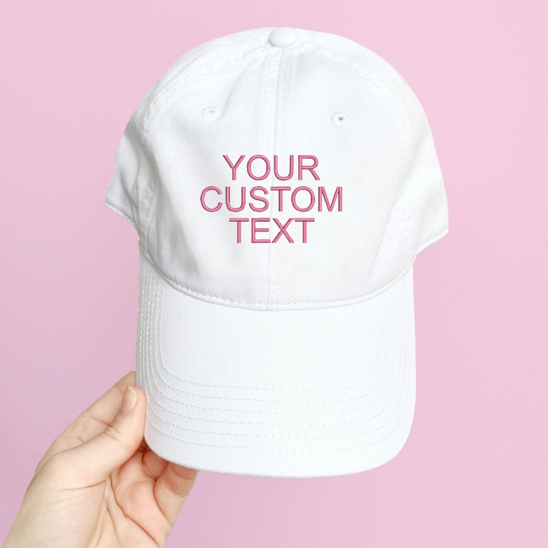 white hat with custom embroidered text in pink thread