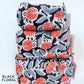 Stack of black floral patterned bags on a white background
