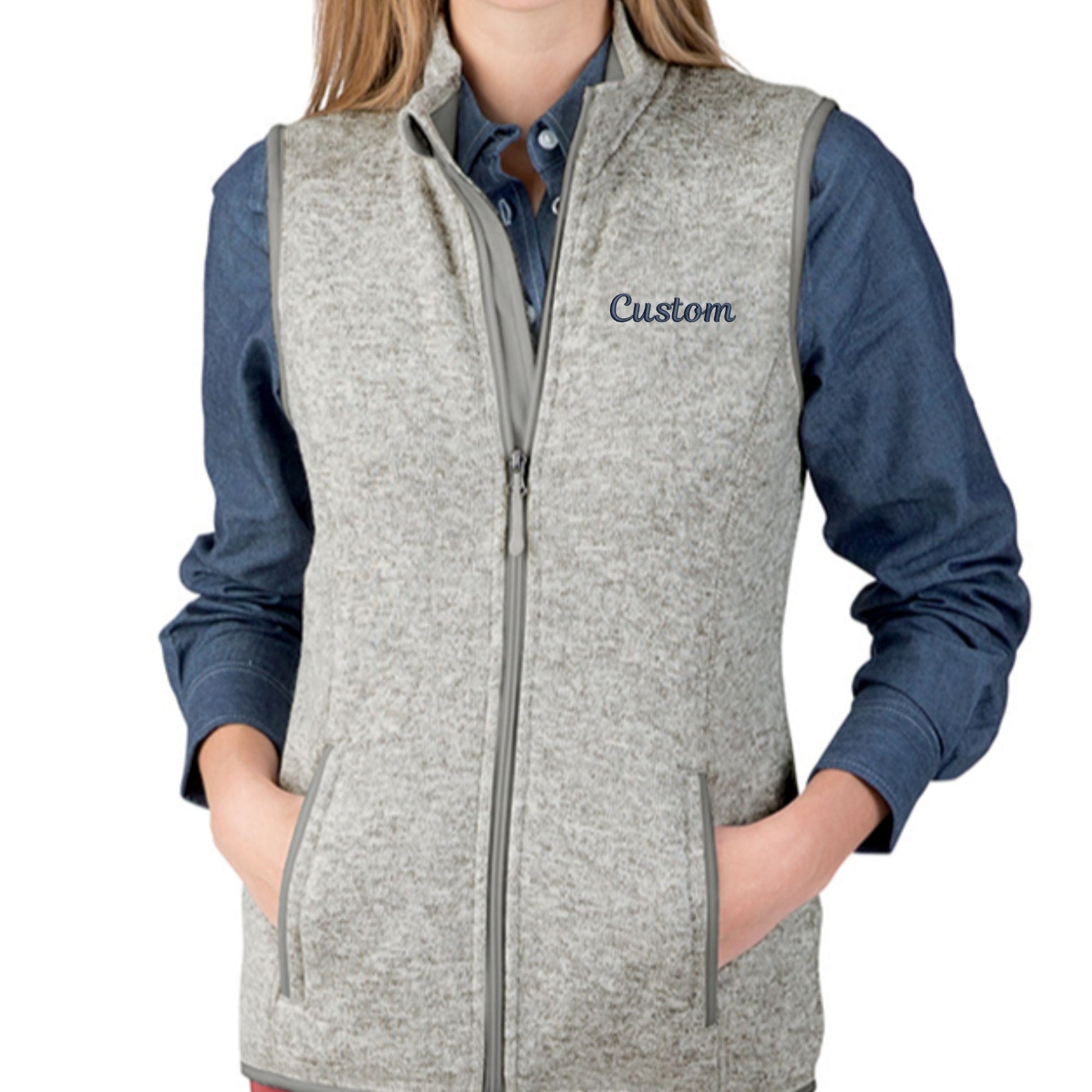 light grey knit fleece vest with 
navy custom embroidered text on the left chest